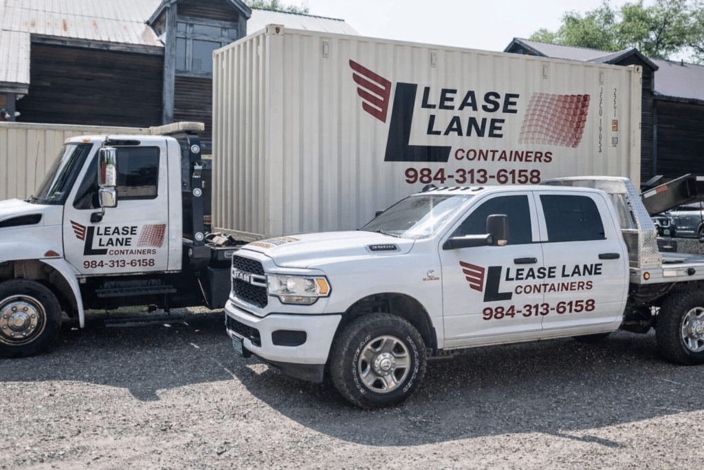 Lease Lane Containers branded delivery truck and service vehicle parked beside a portable storage container